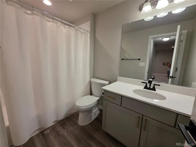 a bathroom with a toilet a sink and a mirror