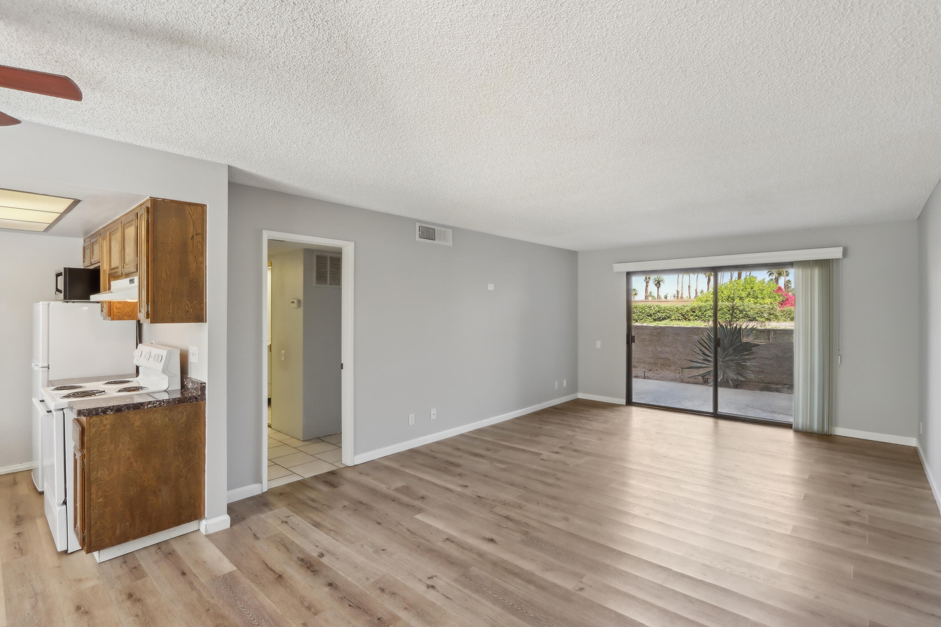 340 East San Jose Road, Unit 99 Palm Springs, CA 92264 - Photo 11 of 26 wooden floor in an empty room with a window