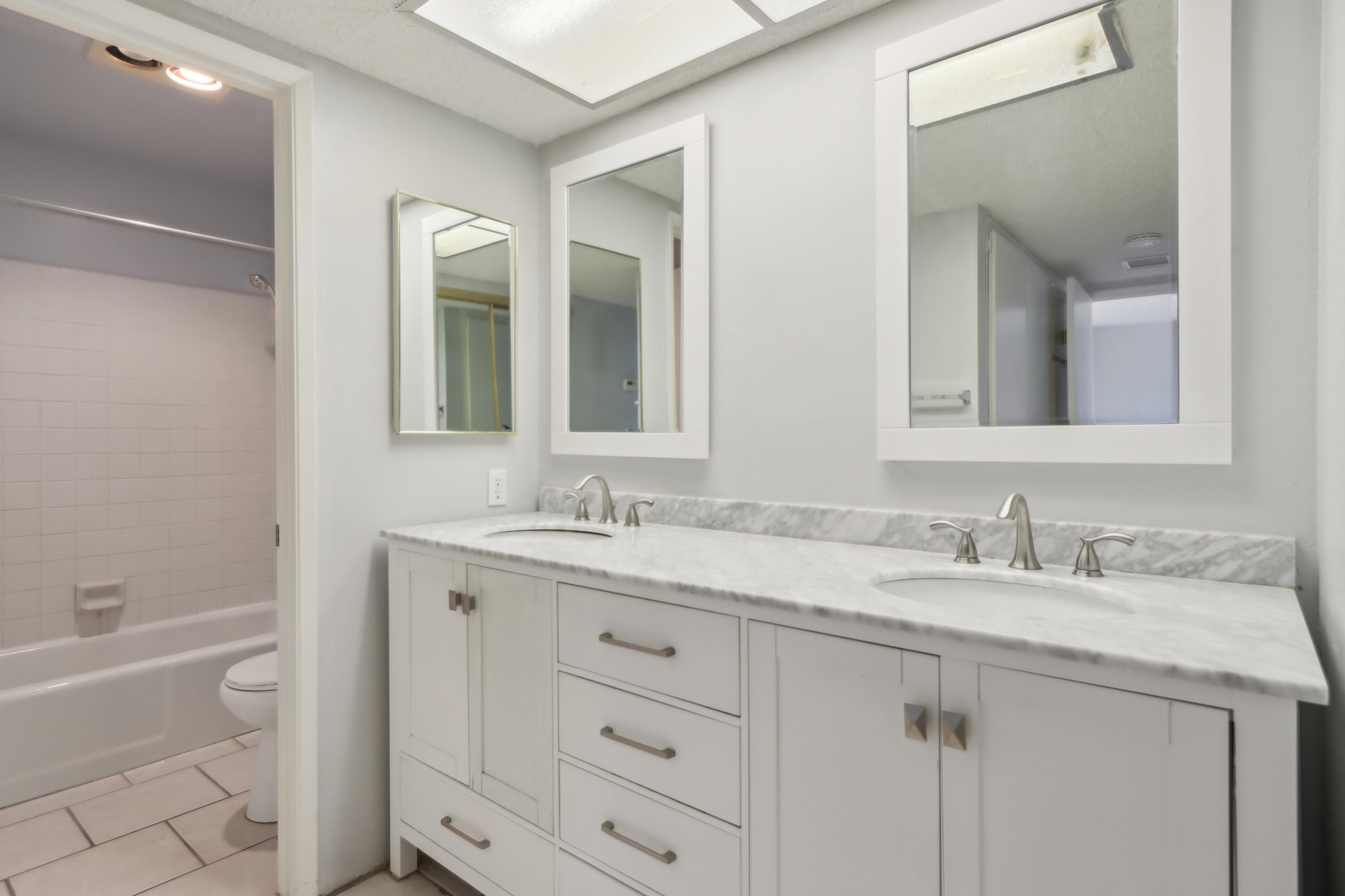 340 East San Jose Road, Unit 99 Palm Springs, CA 92264 - Photo 13 of 26 a bathroom with a granite countertop sink mirror and a bathtub