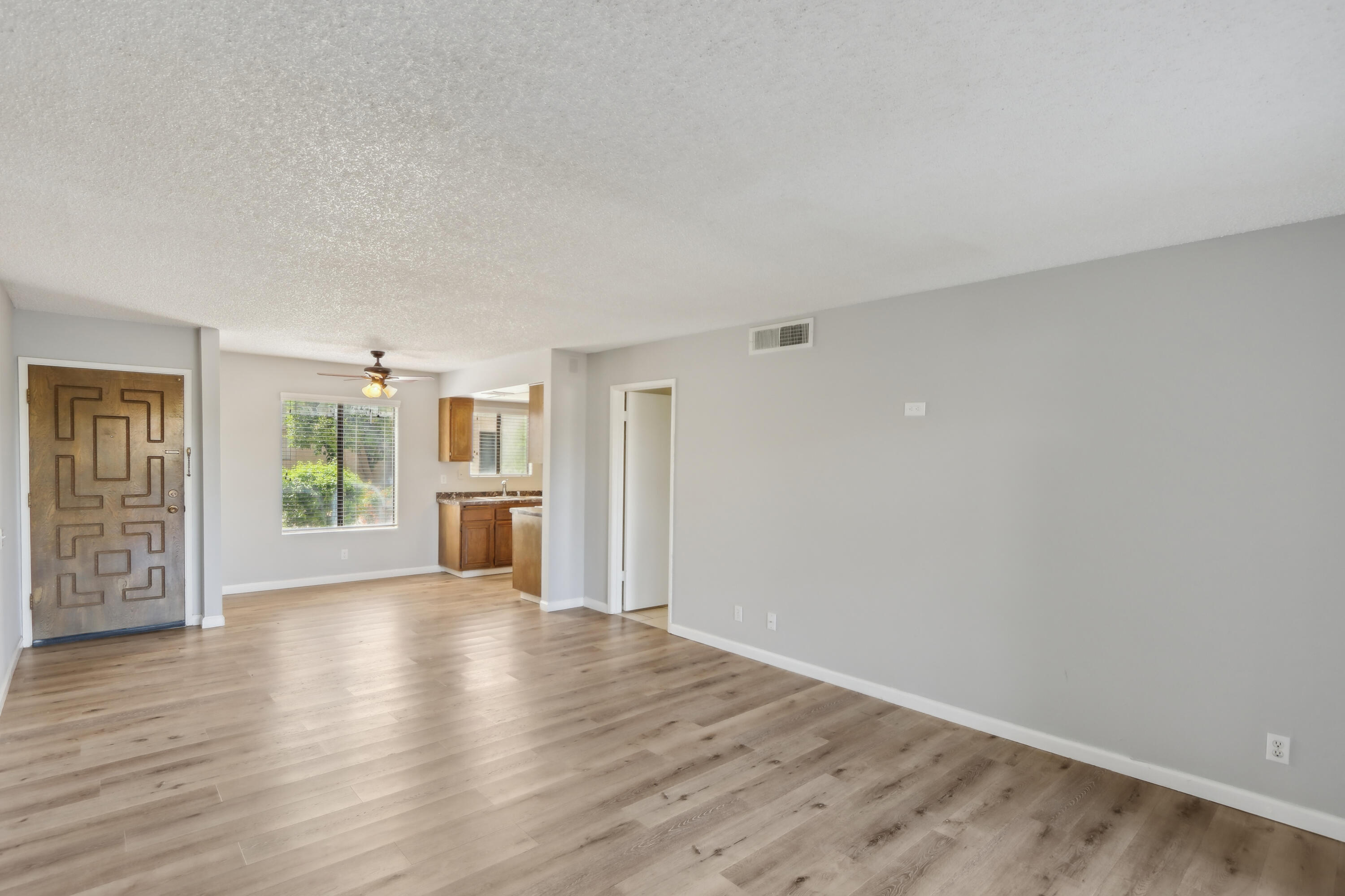 340 East San Jose Road, Unit 99 Palm Springs, CA 92264 - Photo 5 of 26 a view of a big room with wooden floor and windows