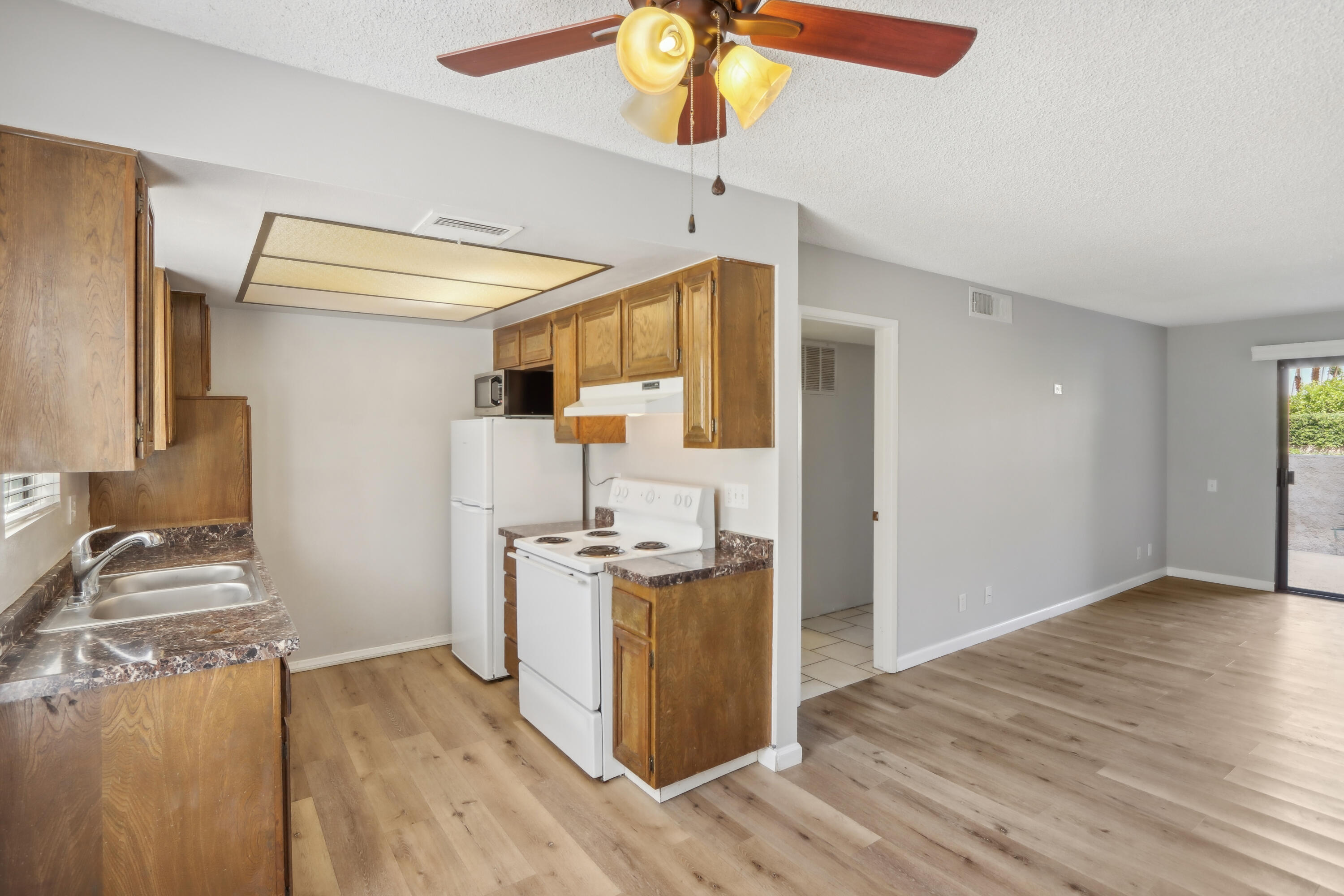 340 East San Jose Road, Unit 99 Palm Springs, CA 92264 - Photo 7 of 26 a kitchen with stainless steel appliances granite countertop a stove and a refrigerator