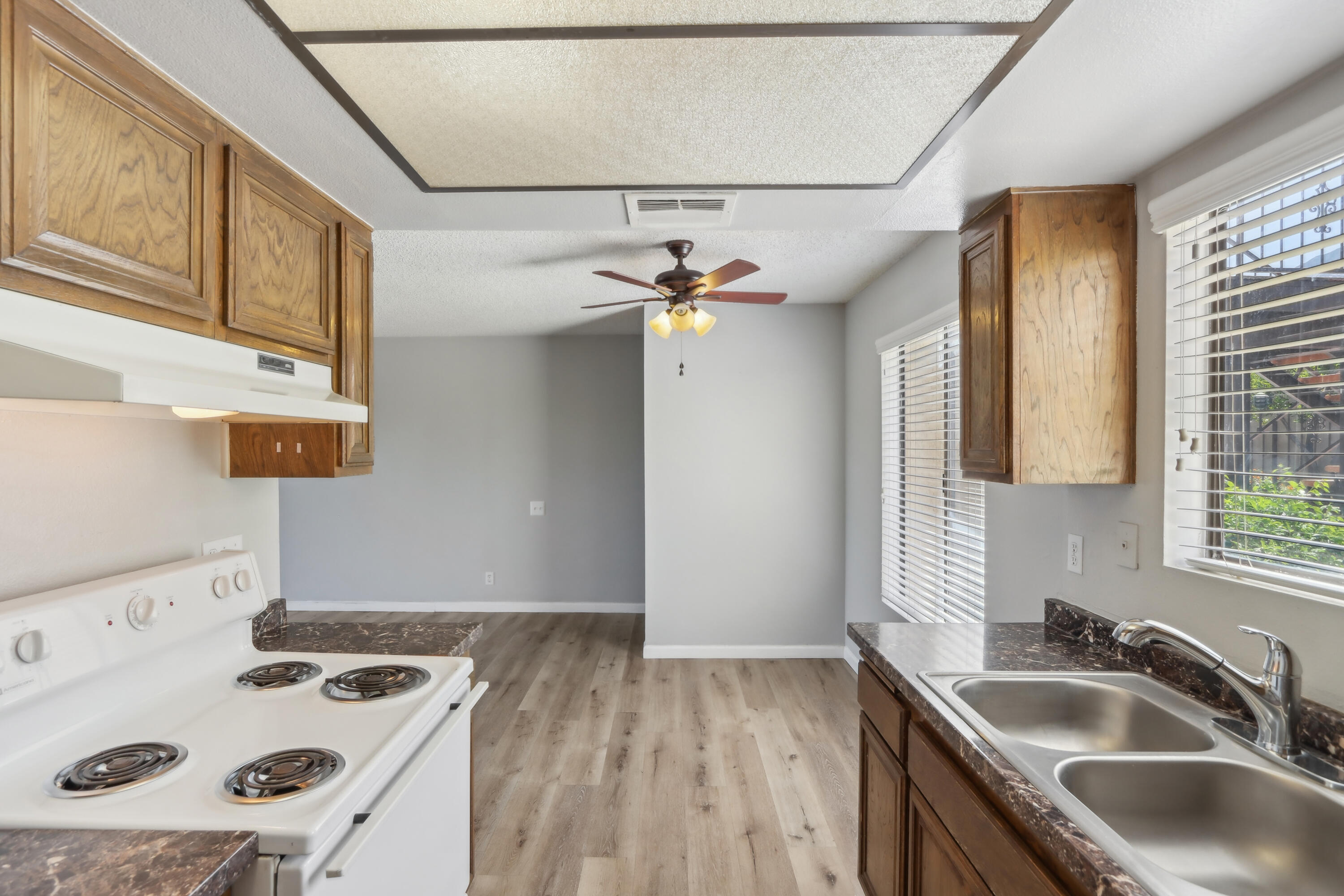 340 East San Jose Road, Unit 99 Palm Springs, CA 92264 - Photo 9 of 26 a kitchen with a sink a stove and a refrigerator