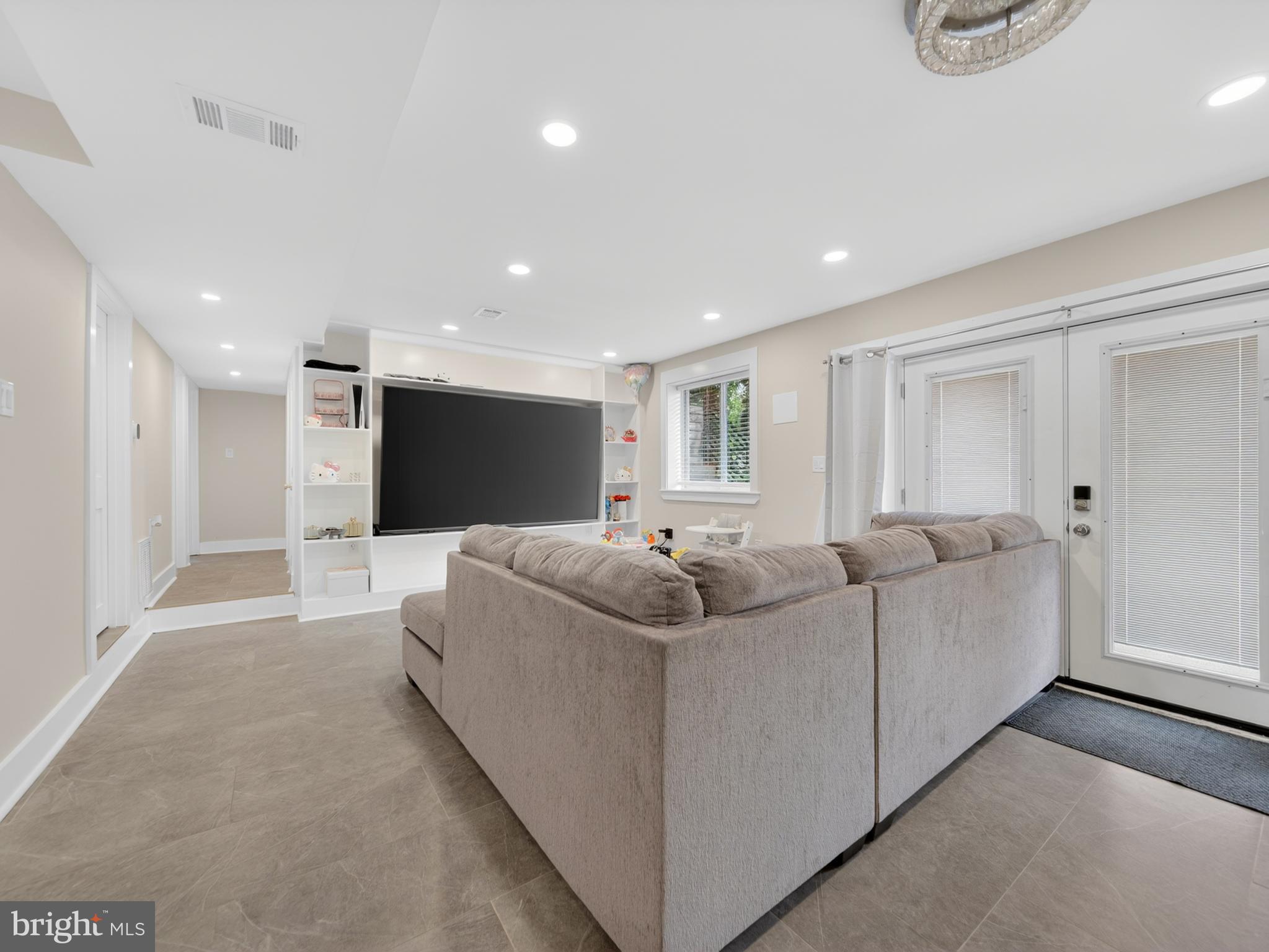 13427 Delaney Road Woodbridge, VA 22193 - Photo 39 of 57 a living room with furniture and a flat screen tv
