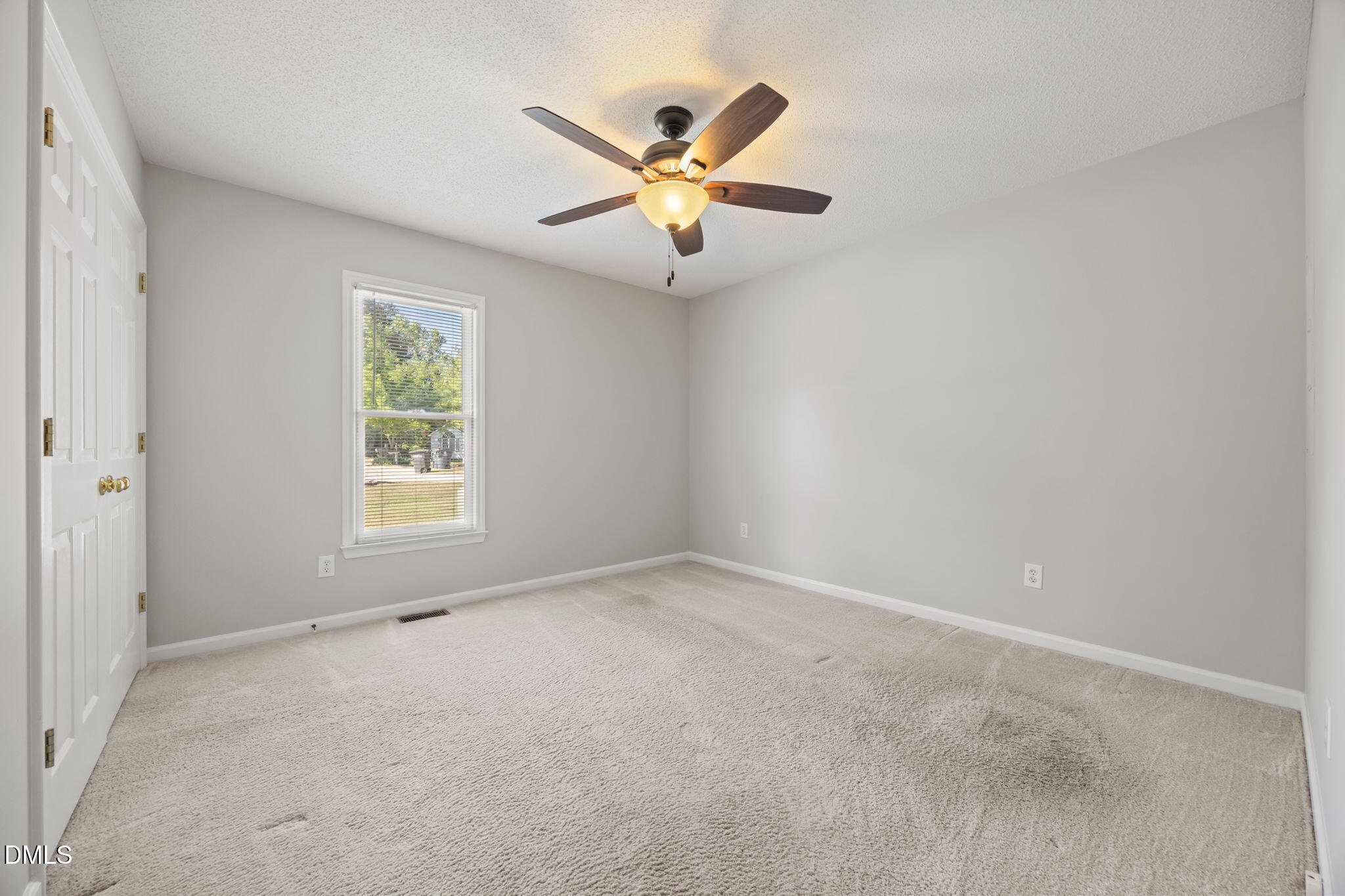 40 Circle Tree Lane Angier, NC 27501 - Photo 18 of 39 an empty room with window and ceiling fan
