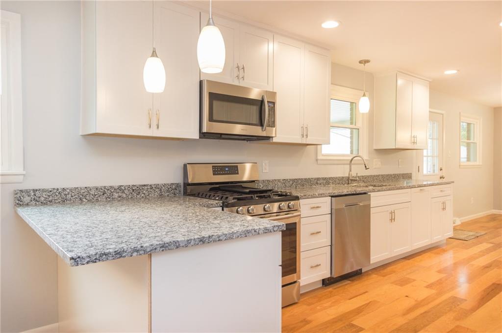 228 Howard Road Sewickley, PA 15143 - Photo 3 of 25 Angle of kitchen showing island area which extends to allow for bar stools. Beautiful granite countertops.