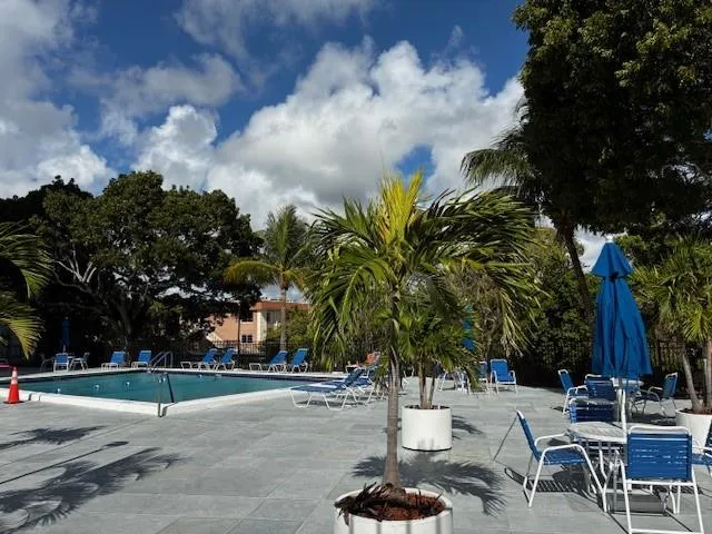 a view of livingroom and dining room with furniture wooden floor and chandelier
