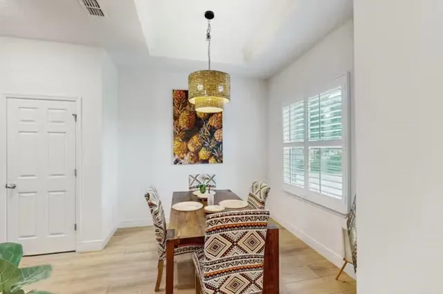 a view of a dining room with furniture window and wooden floor