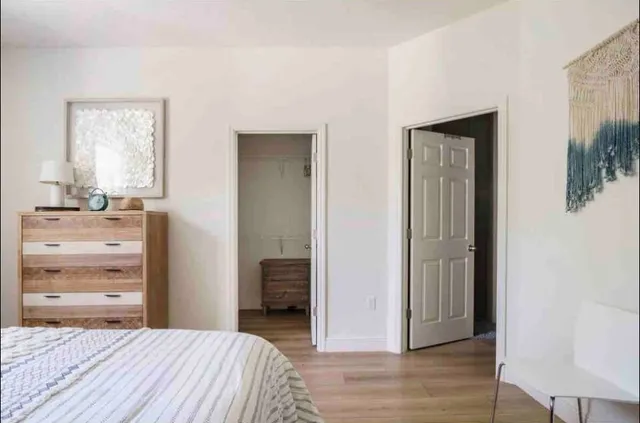 a bedroom with a bed and a dresser