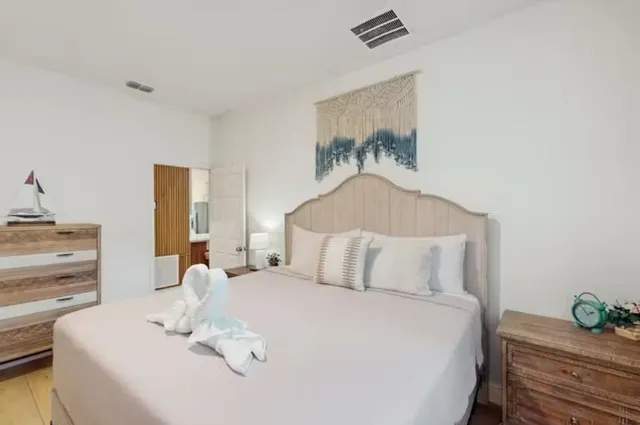 a bedroom with a bed and a painting on the wall