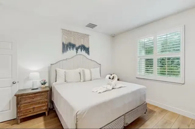 a bedroom with a bed and a window