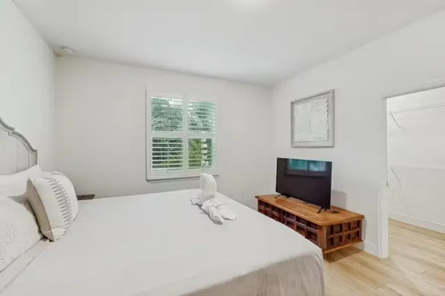 a bedroom with a bed and a television
