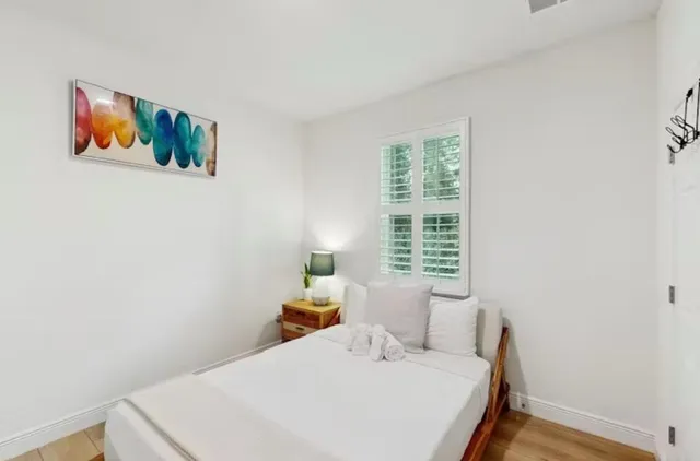 a bedroom with a bed and a window