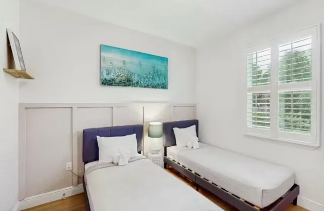 a bedroom with a large bed and a window