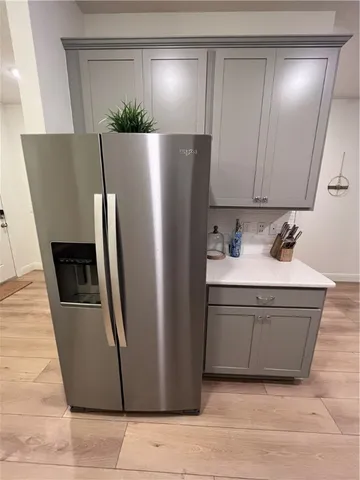 a kitchen with stainless steel appliances granite countertop a refrigerator and a sink