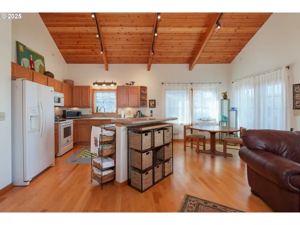a living room with lots of furniture and kitchen view