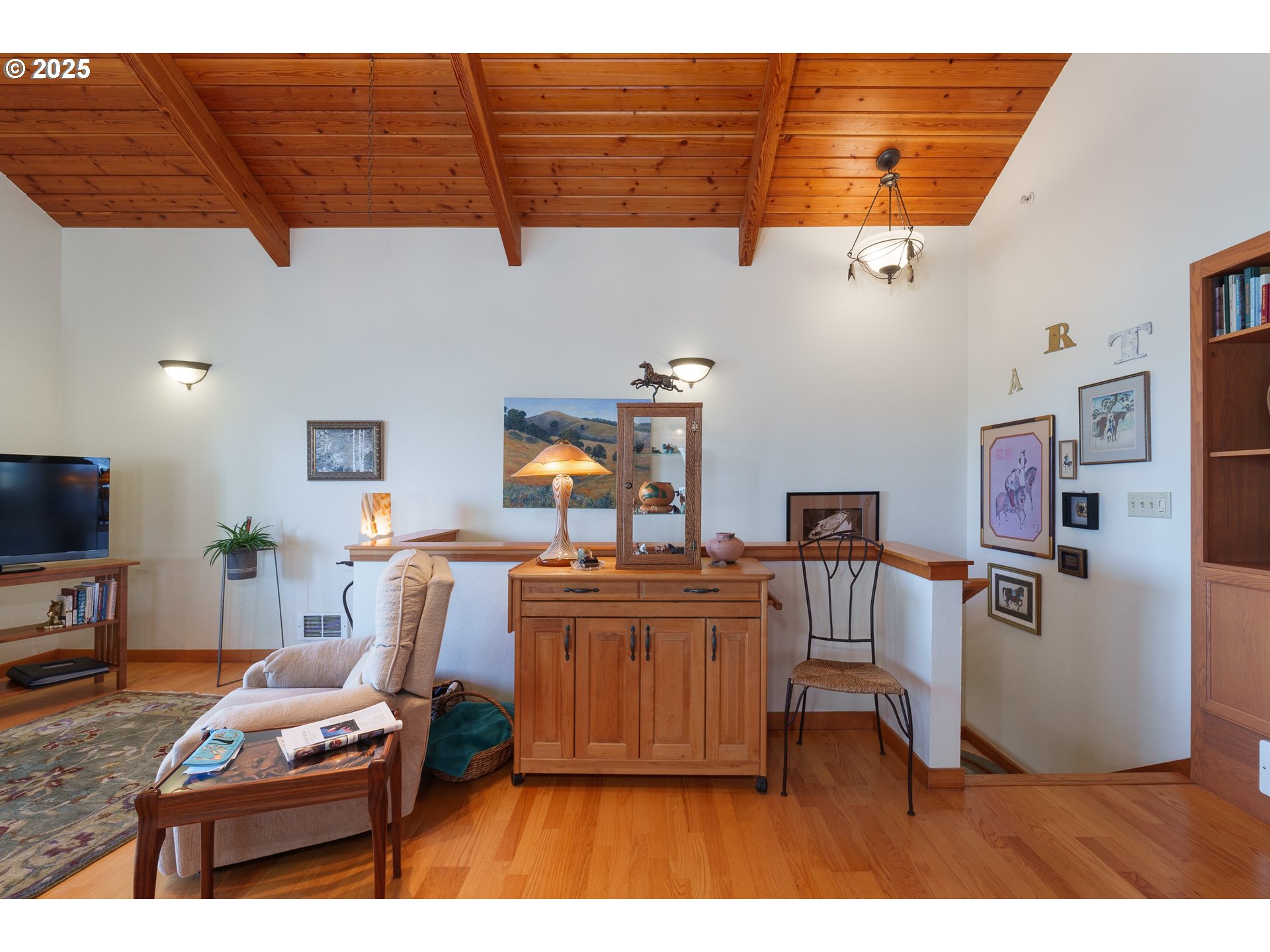1327 Village Loop Bandon, OR 97411 - Photo 15 of 38 a living room with furniture and a flat screen tv