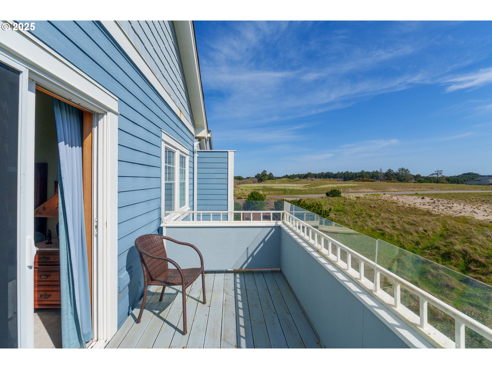 1327 Village Loop Bandon, OR 97411 - Photo 17 of 38 a view of balcony with furniture and wooden floor