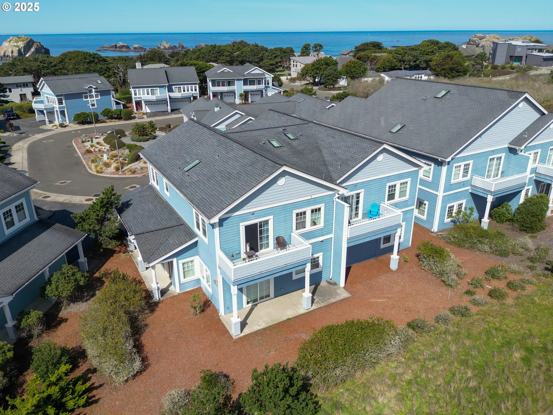 1327 Village Loop Bandon, OR 97411 - Photo 2 of 38 an aerial view of a house with a yard