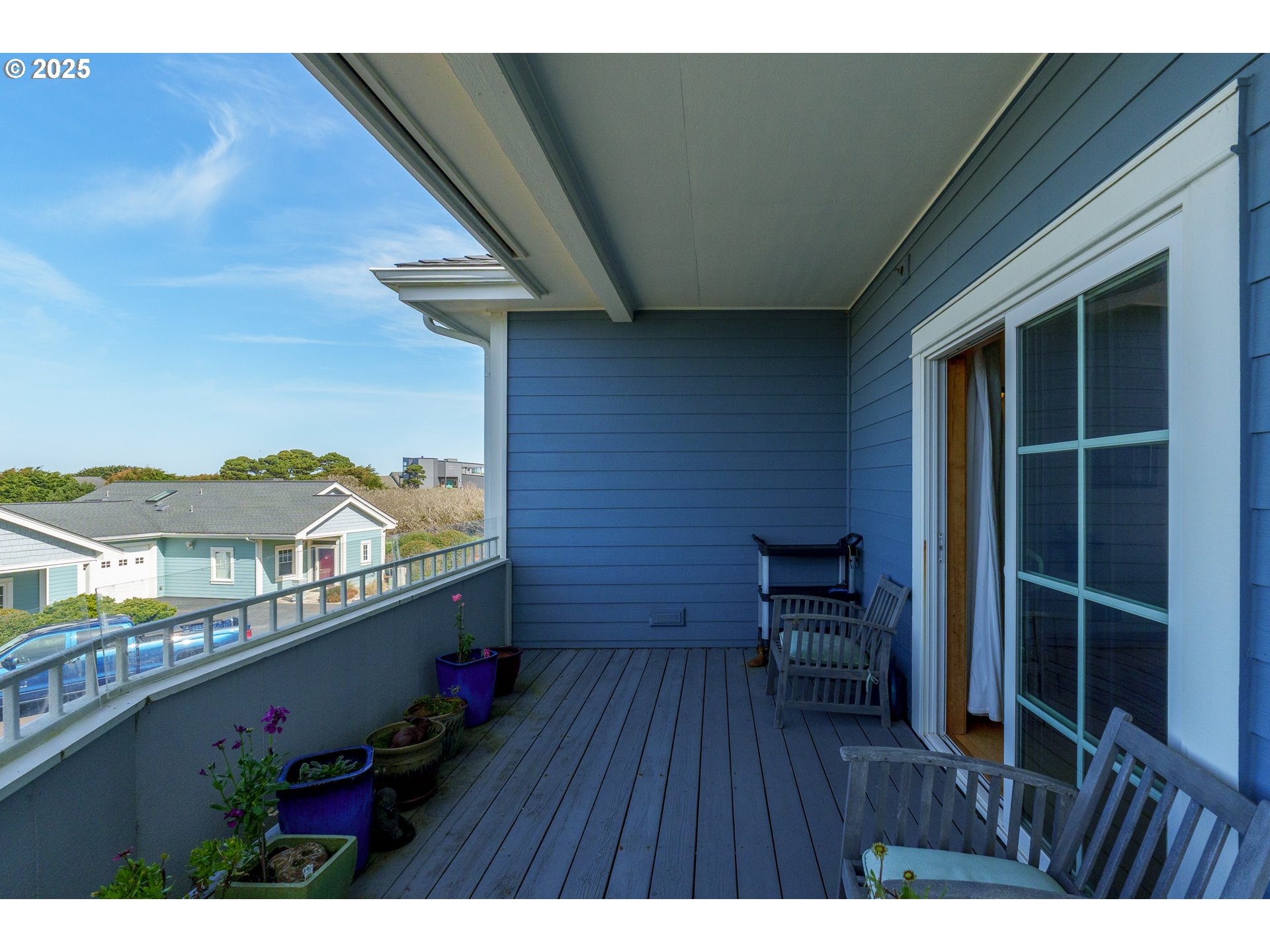 1327 Village Loop Bandon, OR 97411 - Photo 28 of 38 a view of a terrace with chairs and wooden floor