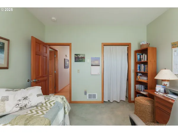 a bedroom with a bed and a lamp