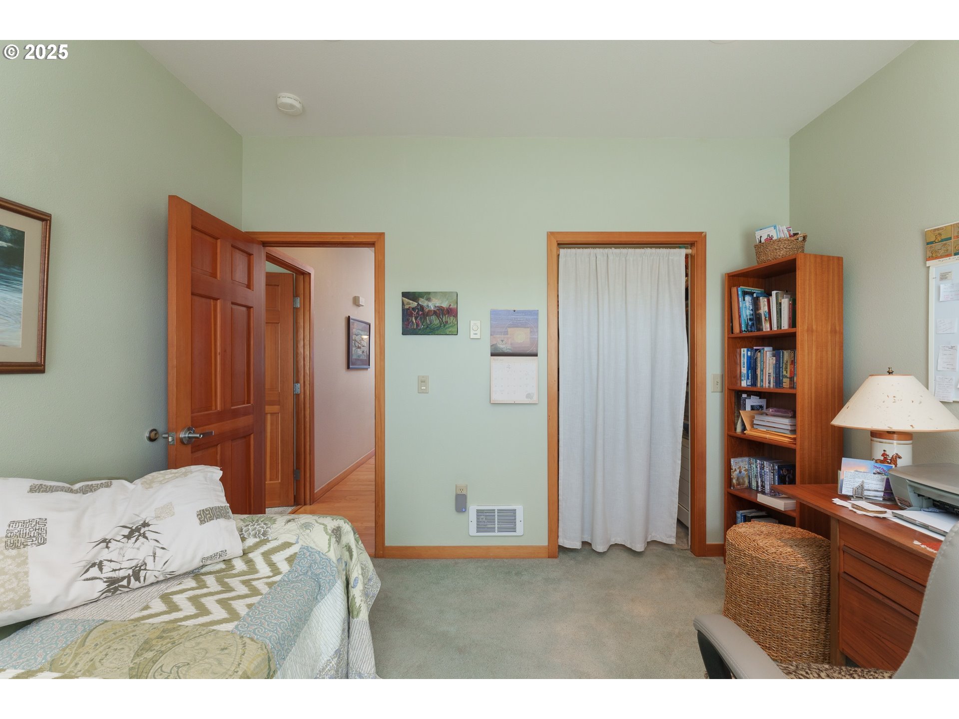 1327 Village Loop Bandon, OR 97411 - Photo 33 of 38 a bedroom with a bed and a lamp