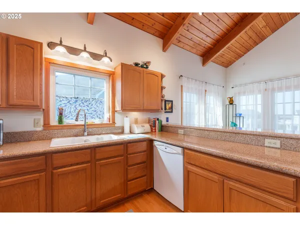 a kitchen with a sink cabinets and a large window