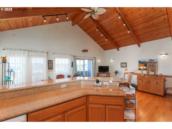 a kitchen with stainless steel appliances granite countertop a sink dishwasher and cabinets with wooden floor