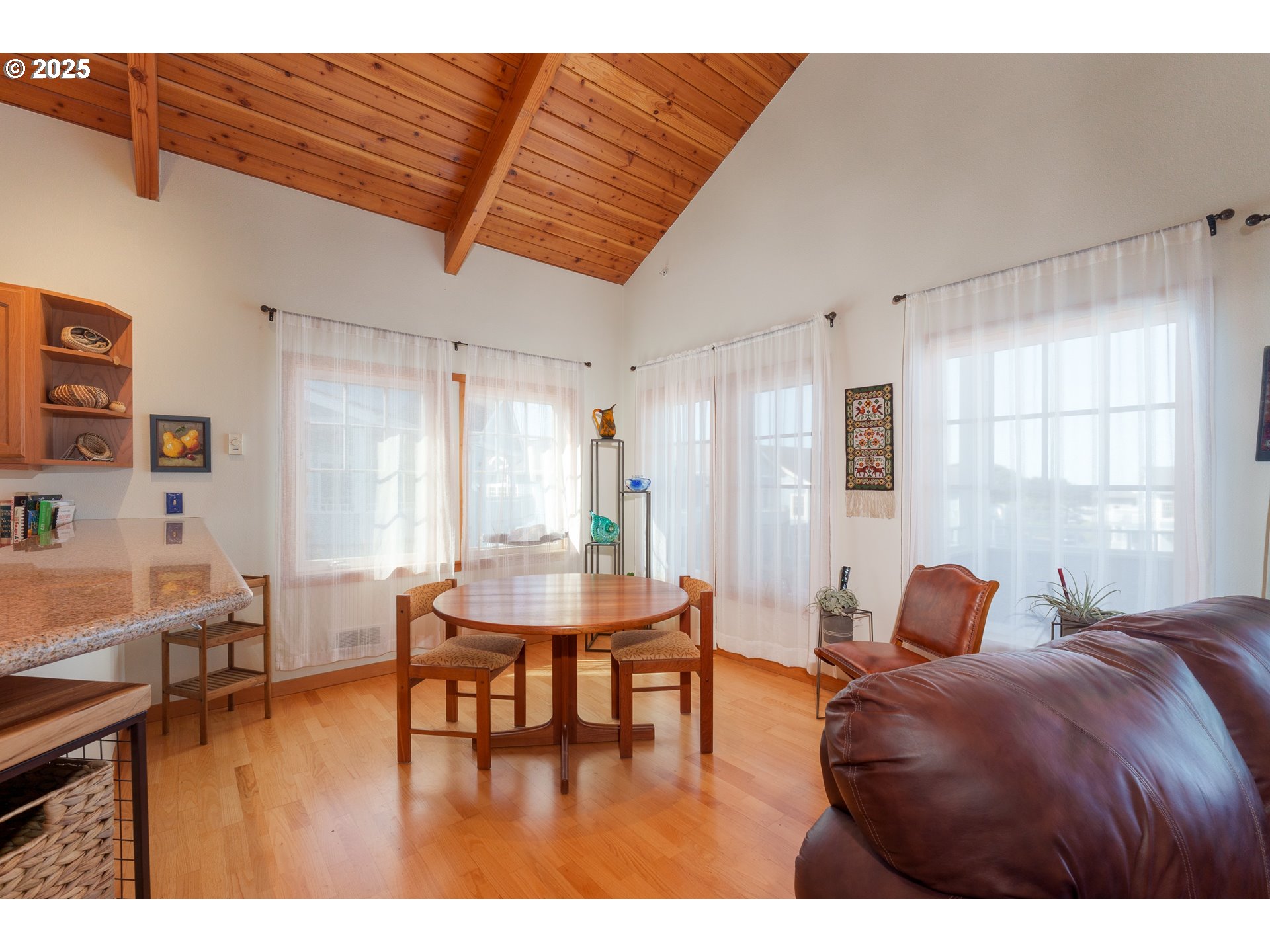 1327 Village Loop Bandon, OR 97411 - Photo 10 of 38 a living room with furniture and a wooden floor