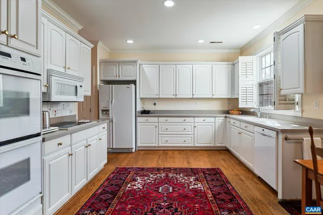 a kitchen with stainless steel appliances granite countertop a refrigerator sink and cabinets