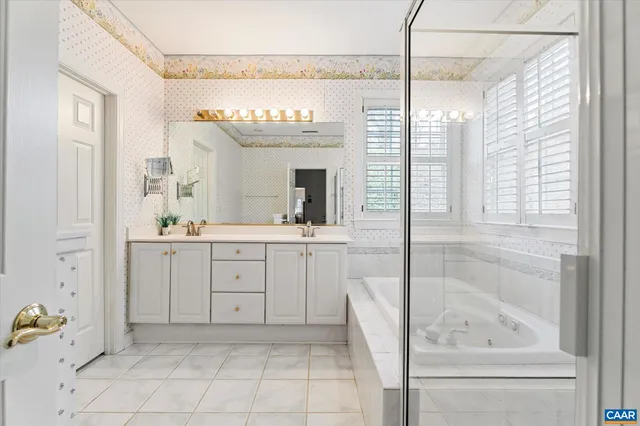 a bathroom with bathtub and window