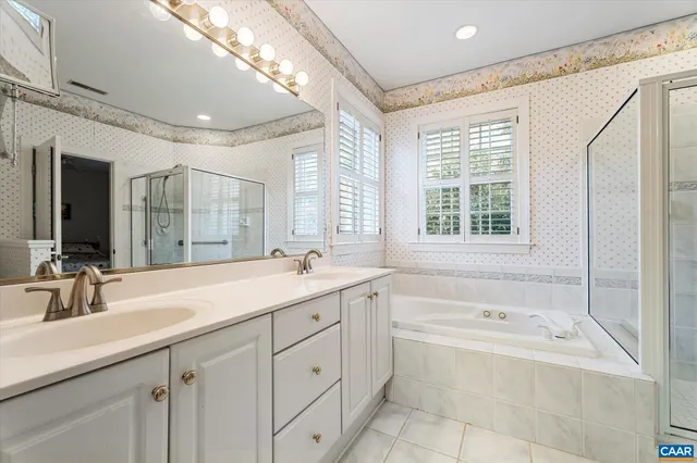 a spacious bedroom with two beds and painted walls