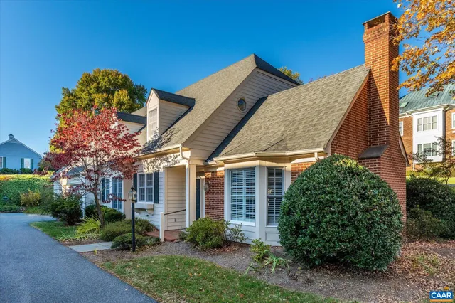 a front view of house with a garden