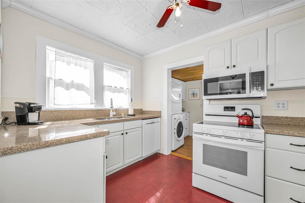 525 Bay Street Dunedin, FL 34698 - Photo 12 of 38 a kitchen with granite countertop cabinets stainless steel appliances and a sink