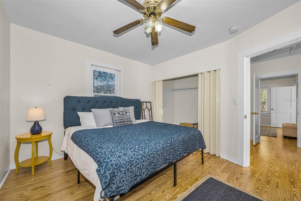 525 Bay Street Dunedin, FL 34698 - Photo 17 of 38 a bedroom with a bed and a chandelier