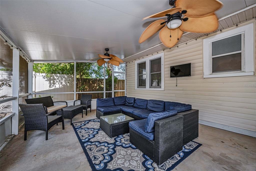 525 Bay Street Dunedin, FL 34698 - Photo 23 of 38 a living room with furniture a flat screen tv and a large window
