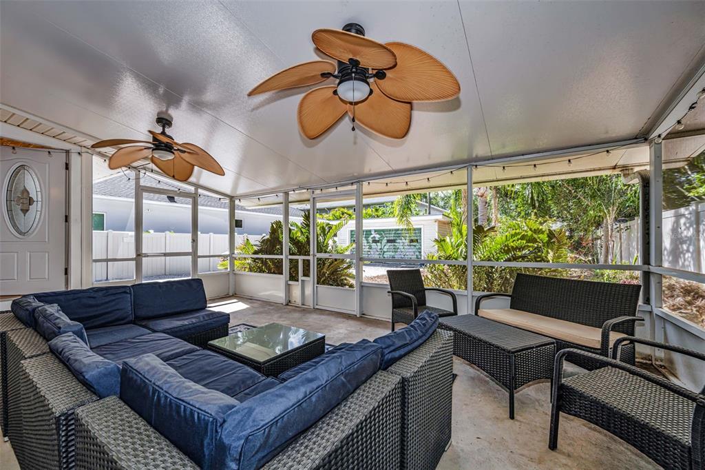 525 Bay Street Dunedin, FL 34698 - Photo 24 of 38 a living room with furniture a ceiling fan and a large window