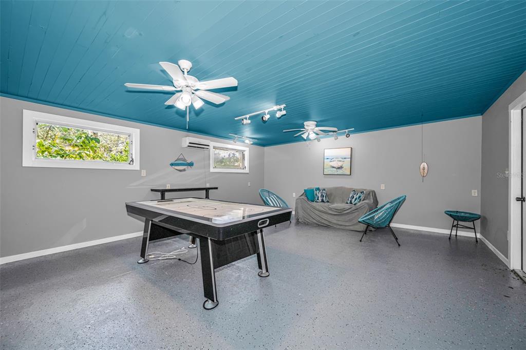 525 Bay Street Dunedin, FL 34698 - Photo 27 of 38 a workspace with furniture and chandelier