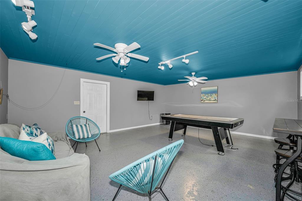 525 Bay Street Dunedin, FL 34698 - Photo 29 of 38 a workspace with furniture and a chandelier