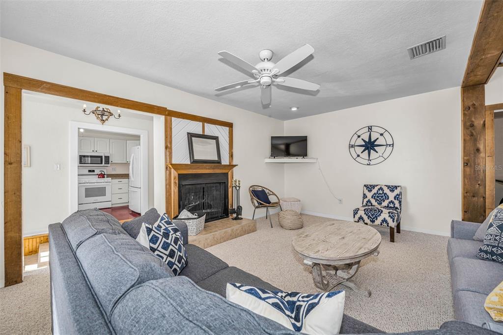 525 Bay Street Dunedin, FL 34698 - Photo 7 of 38 a living room with fireplace furniture and a table