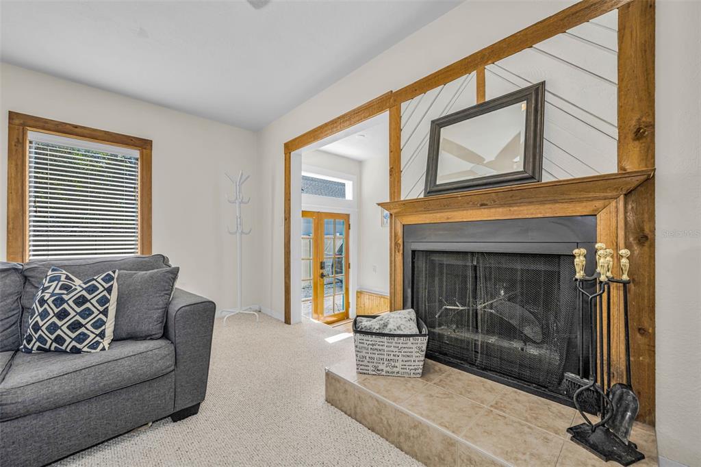 525 Bay Street Dunedin, FL 34698 - Photo 8 of 38 a living room with furniture and a fireplace