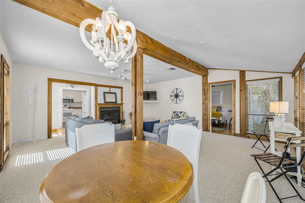 525 Bay Street Dunedin, FL 34698 - Photo 10 of 38 a view of a dining room with furniture wooden floor and chandelier
