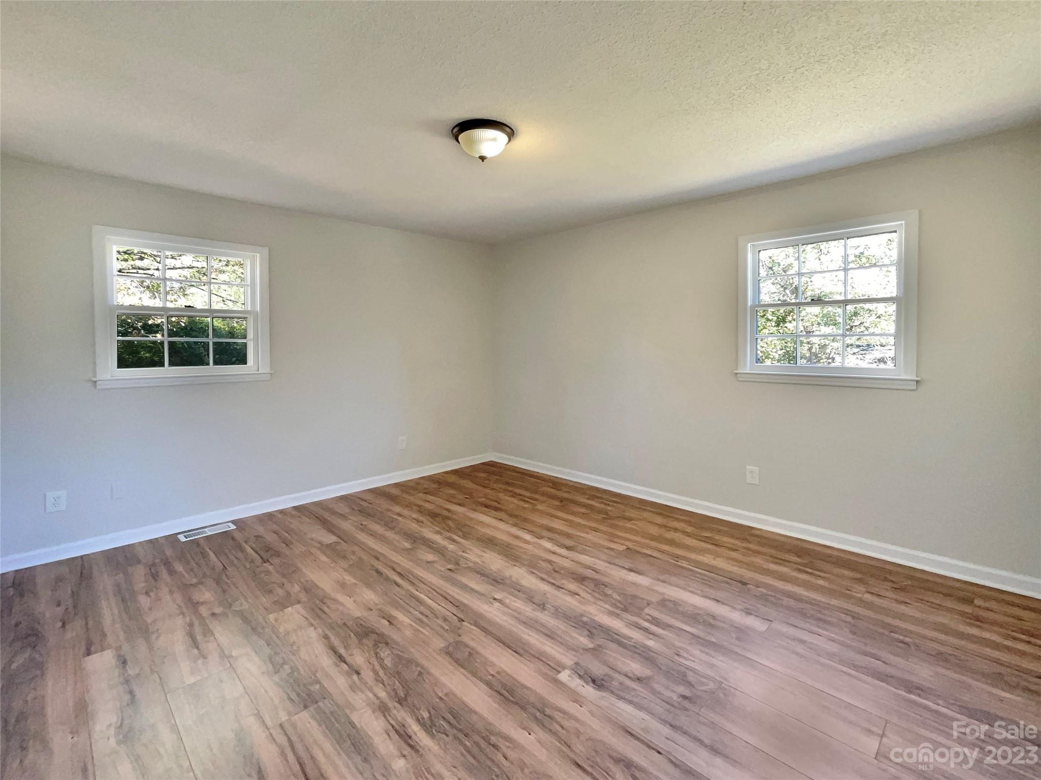 1904 Bess Town Road Bessemer City, NC 28016 - Photo 16 of 18 a view of empty room with wooden floor and fan
