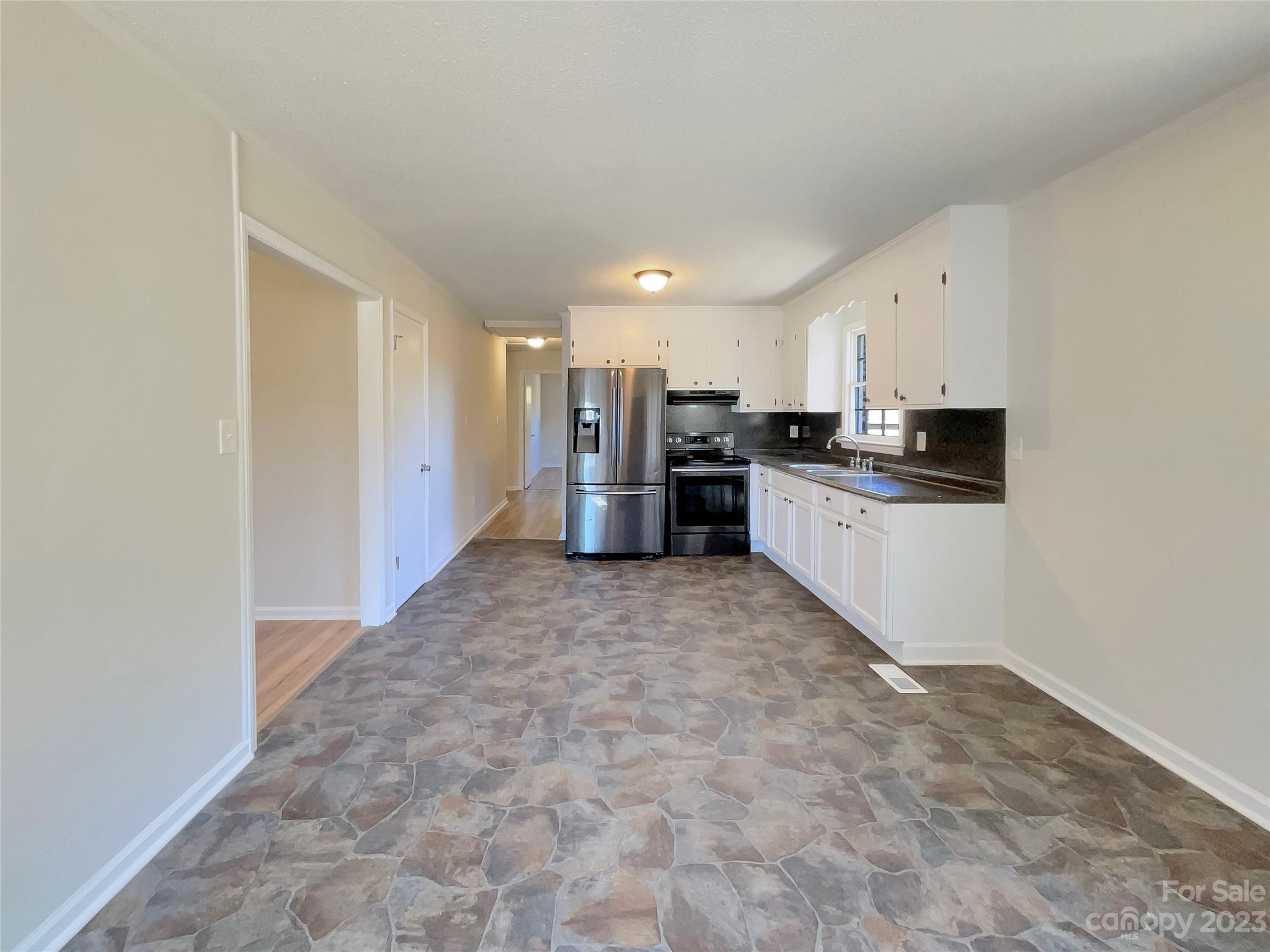 1904 Bess Town Road Bessemer City, NC 28016 - Photo 9 of 18 a kitchen with stainless steel appliances granite countertop a refrigerator and a stove top oven