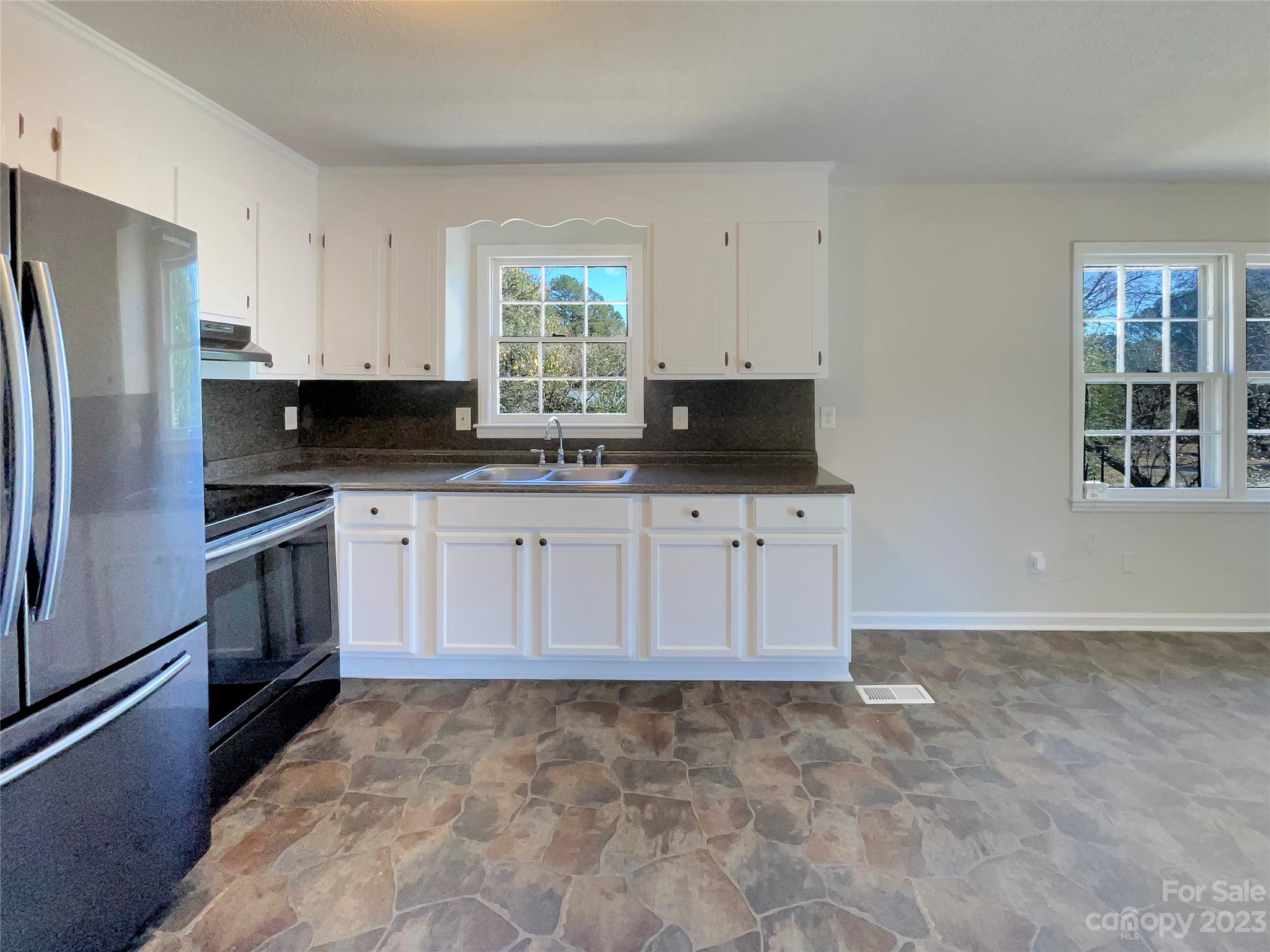 1904 Bess Town Road Bessemer City, NC 28016 - Photo 10 of 18 a kitchen with stainless steel appliances a stove a sink and a refrigerator