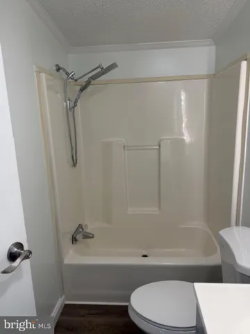 a bathroom with a toilet and a bathtub