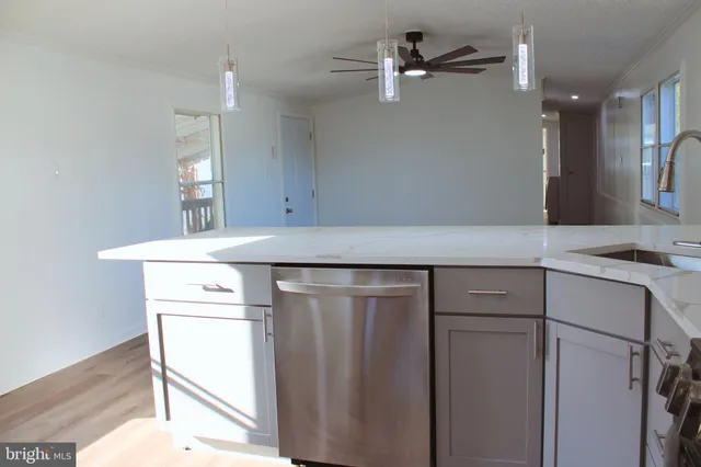 a kitchen with a sink cabinets and wooden floor