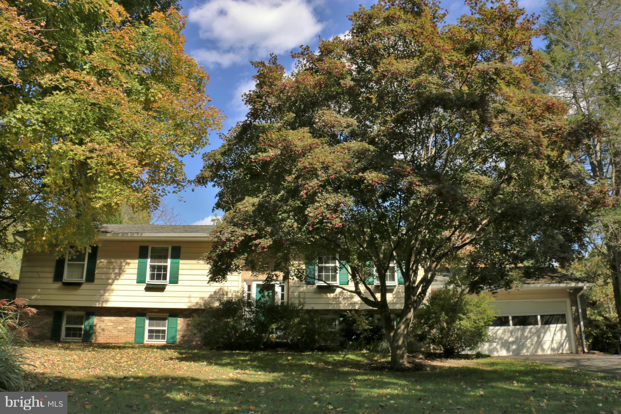 13831 Manor Road Baldwin, MD 21013 - Photo 1 of 20 a front view of a house with a garden