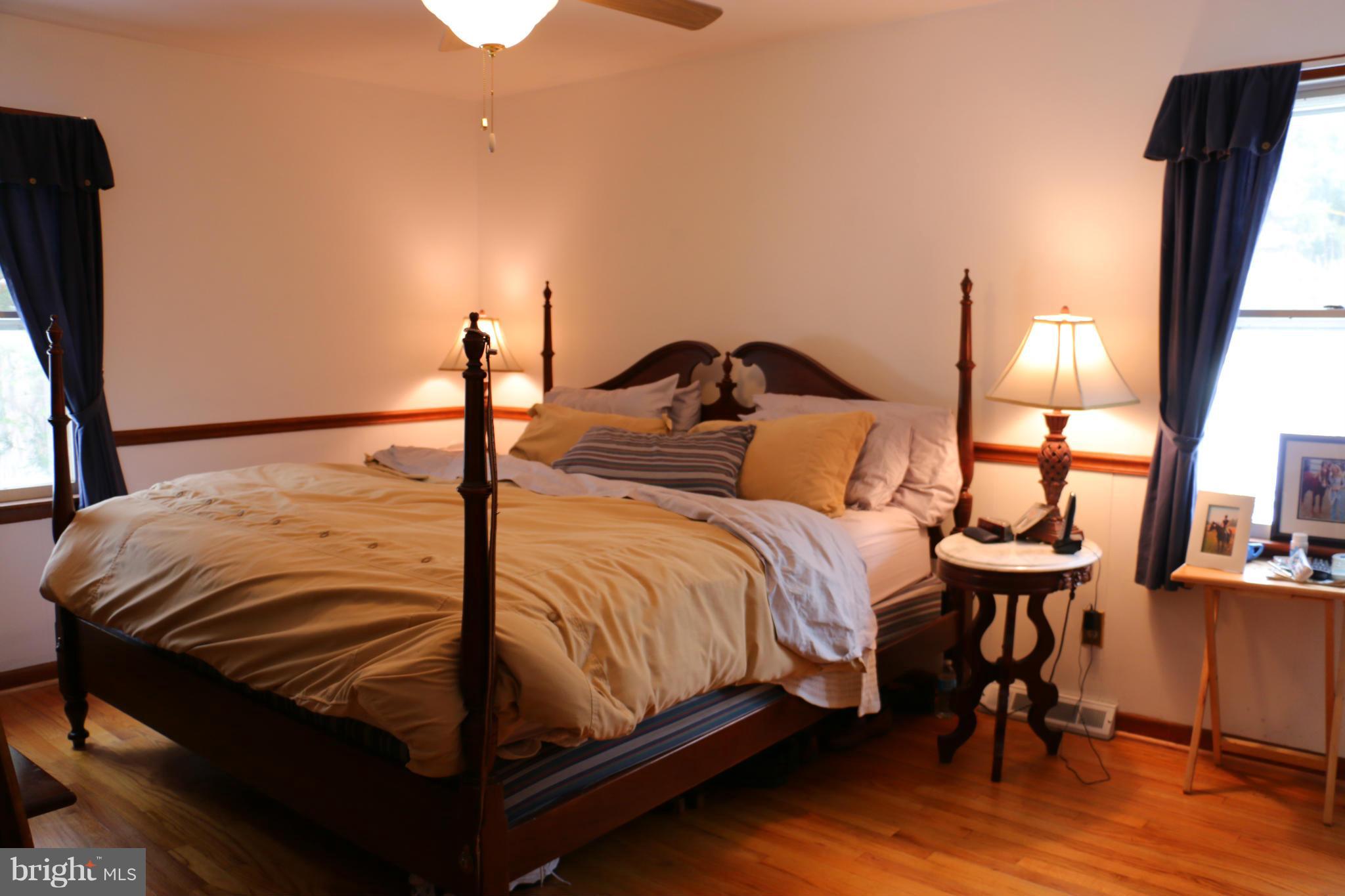 13831 Manor Road Baldwin, MD 21013 - Photo 12 of 20 a bedroom with a bed and wooden floor