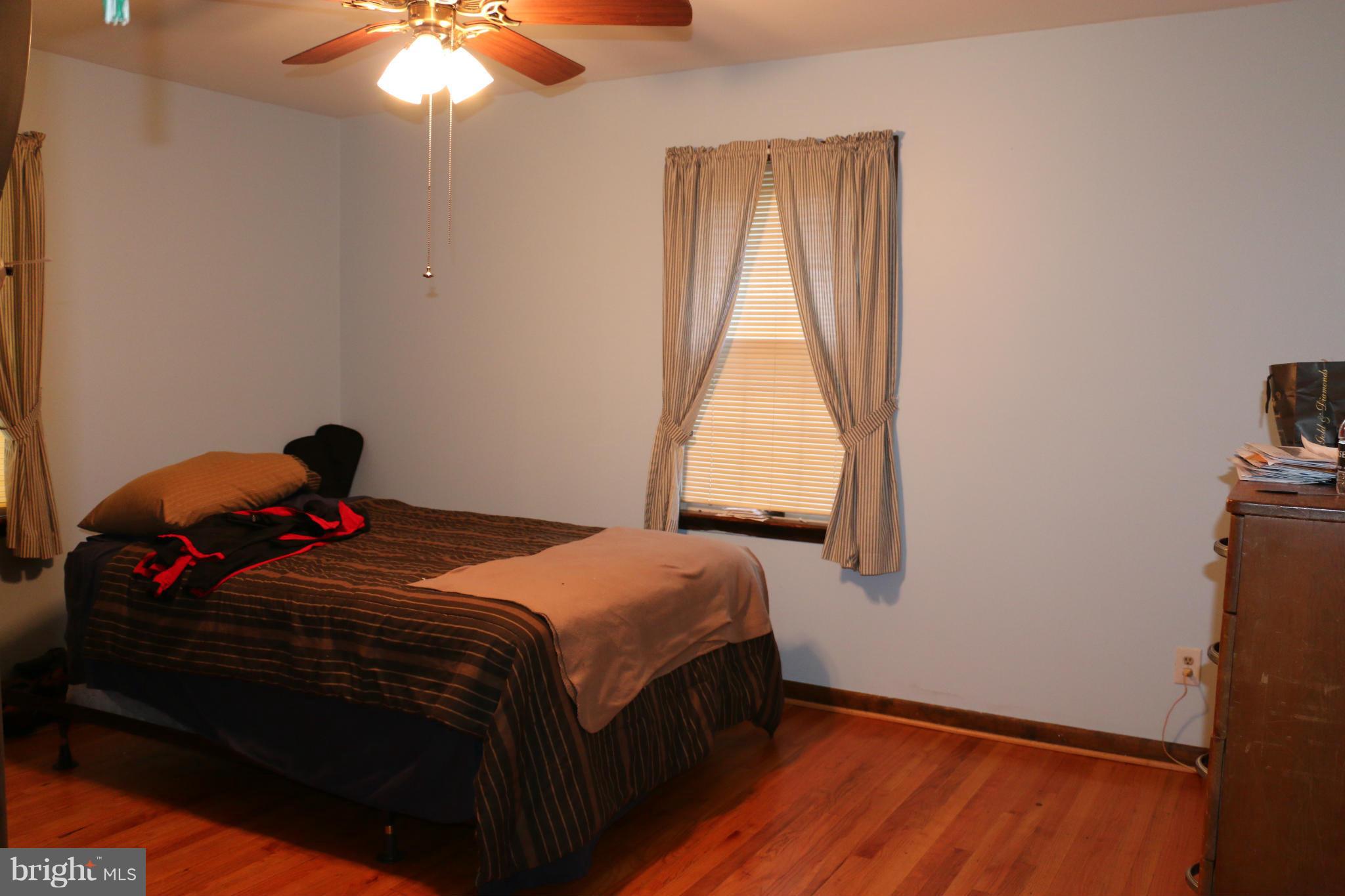 13831 Manor Road Baldwin, MD 21013 - Photo 13 of 20 a bedroom with a bed and a window