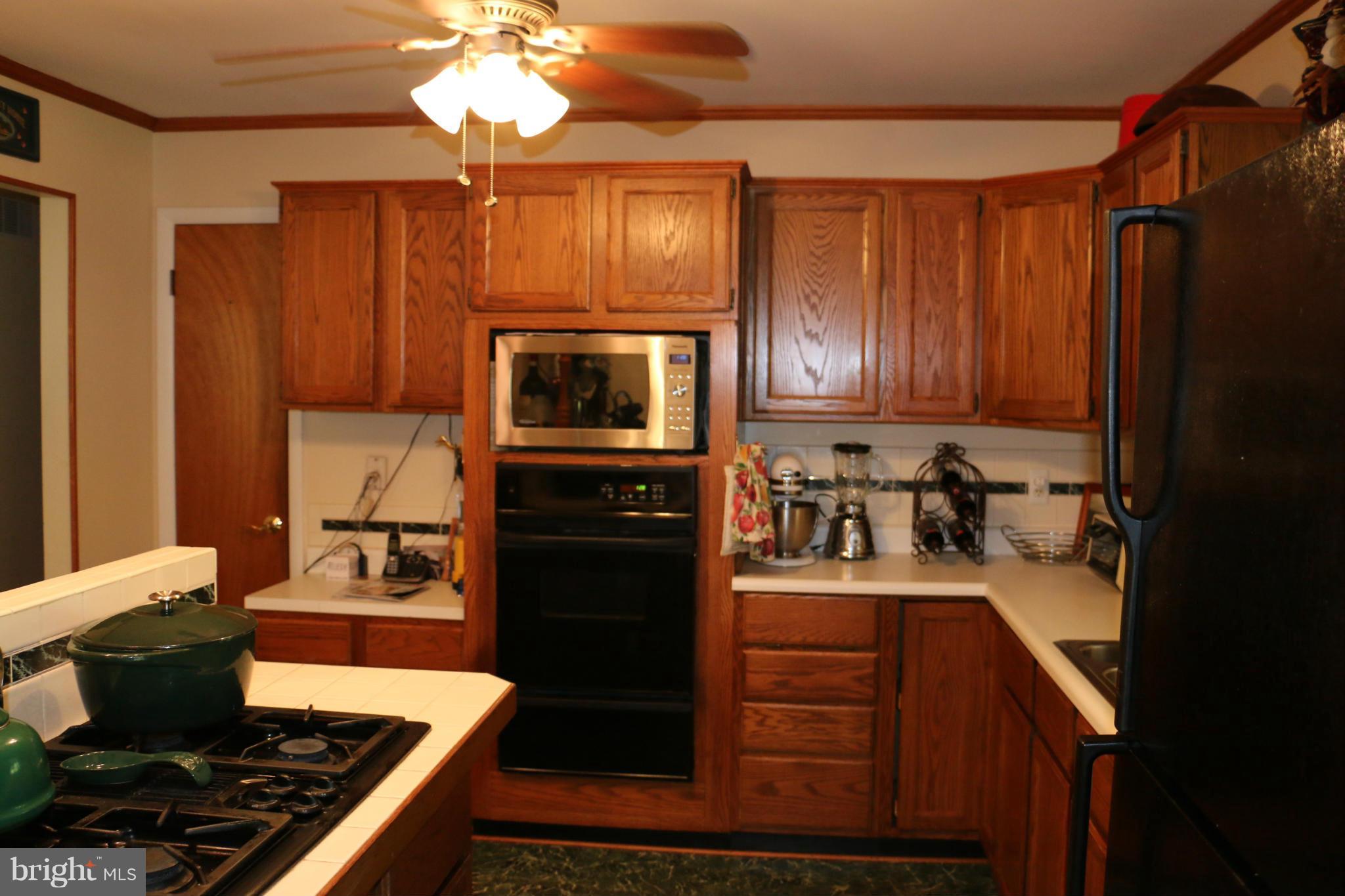 13831 Manor Road Baldwin, MD 21013 - Photo 4 of 20 a kitchen with a stove a sink and a microwave